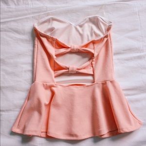 Coral strapless peplum top.